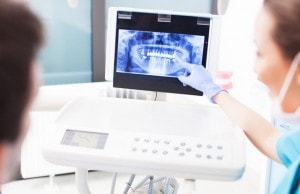 Dentist explaining x ray picture to patient